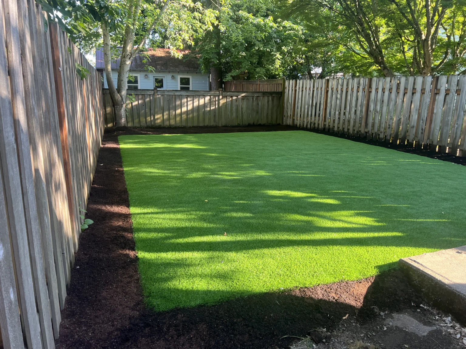 Pet-friendly artificial grass installation in Portland, OR, designed for residential backyards